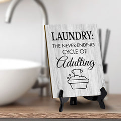 Signs ByLITA Laundry: The never-ending cycle of adulting Table Sign with Acrylic Stand (6x8“)