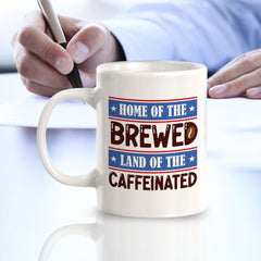 Home Of The Brewed, Land Of The Caffeinated 11oz Plastic or Ceramic Coffee Mug | Funny Patriotic Novelty Office Mug