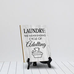 Signs ByLITA Laundry: The never-ending cycle of adulting Table Sign with Acrylic Stand (6x8“)