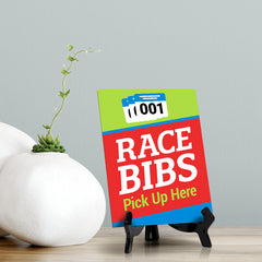 Signs ByLITA Race Bibs: Pick Up Here Table Sign with Acrylic Stand (6x8“)