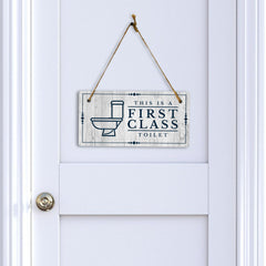 This is a First-Class Toilet 5x10 Hanging Wall or Door Sign | Warm Welcoming Signage For Homes