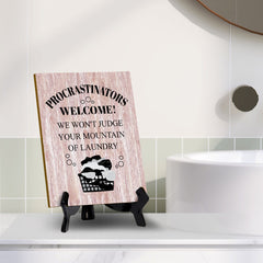 Signs ByLITA Procrastinators welcome! We won't judge your mountain of laundry Table Sign with Acrylic Stand (6x8“)