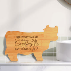 Designs ByLITA I Solemnly Swear That My Cooking Tastes Good 14.75 x 9.75" Cow Shape Cutting Board | Funny Kitchen Chopping Board