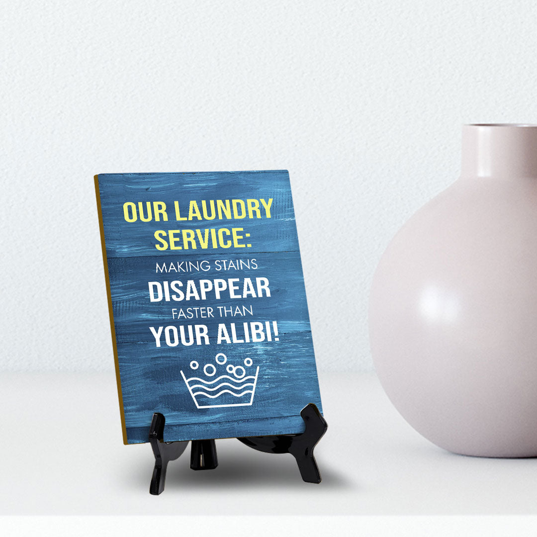 Signs ByLITA Our laundry service: Making stains disappear faster than your alibi! Table Sign with Acrylic Stand (6x8“)