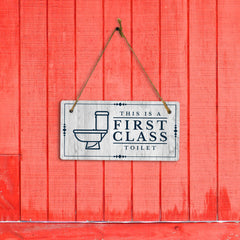 This is a First-Class Toilet 5x10 Hanging Wall or Door Sign | Warm Welcoming Signage For Homes