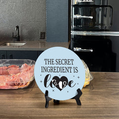 The Secret Ingredient Is Love Circle Table Sign with Acrylic Stand (5x5") | Funny Home Decor