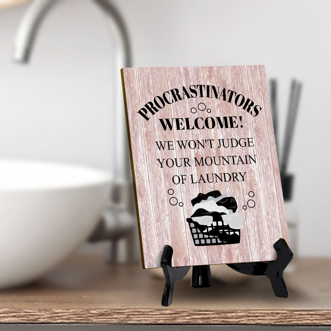 Signs ByLITA Procrastinators welcome! We won't judge your mountain of laundry Table Sign with Acrylic Stand (6x8“)